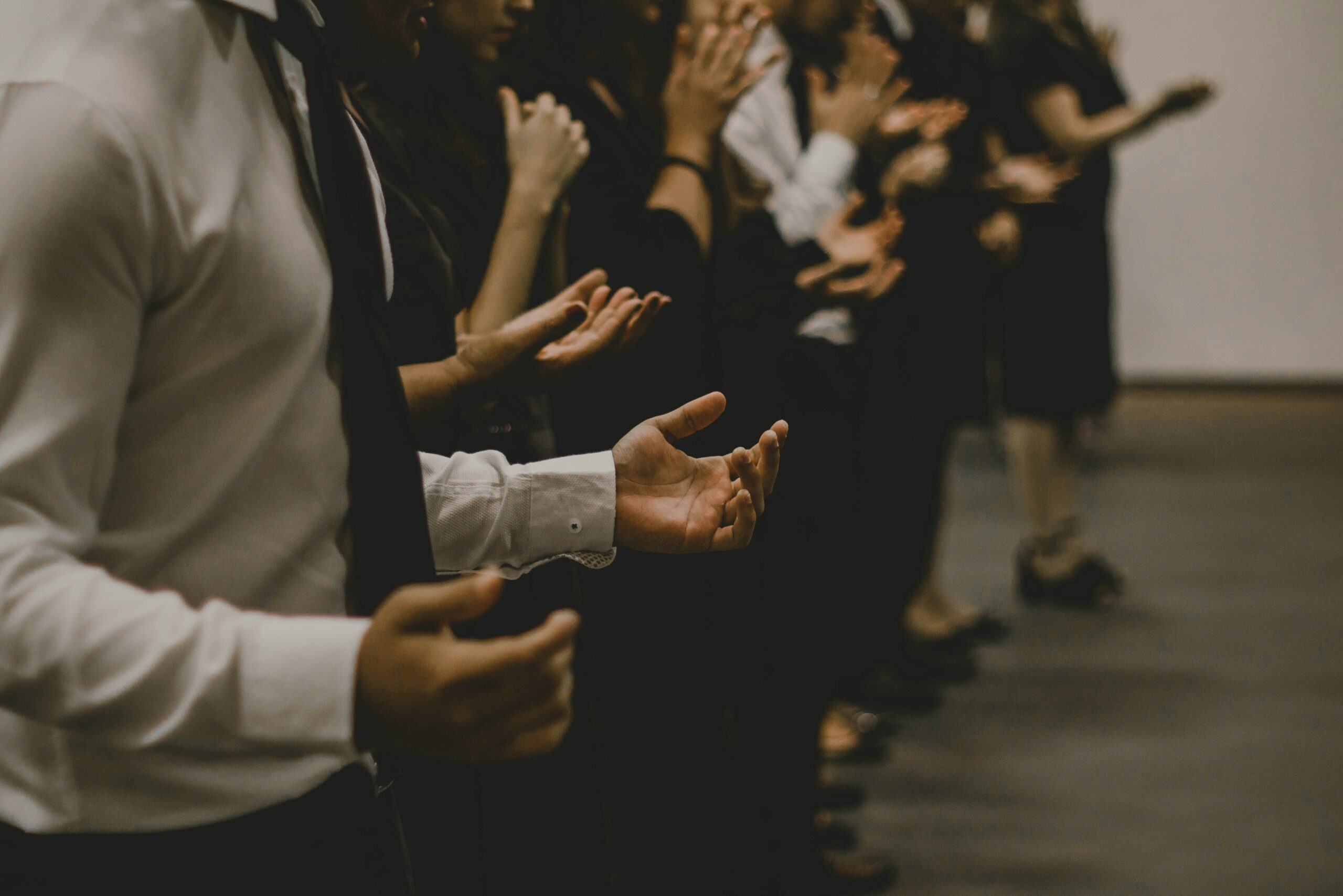 People standing with palms facing up